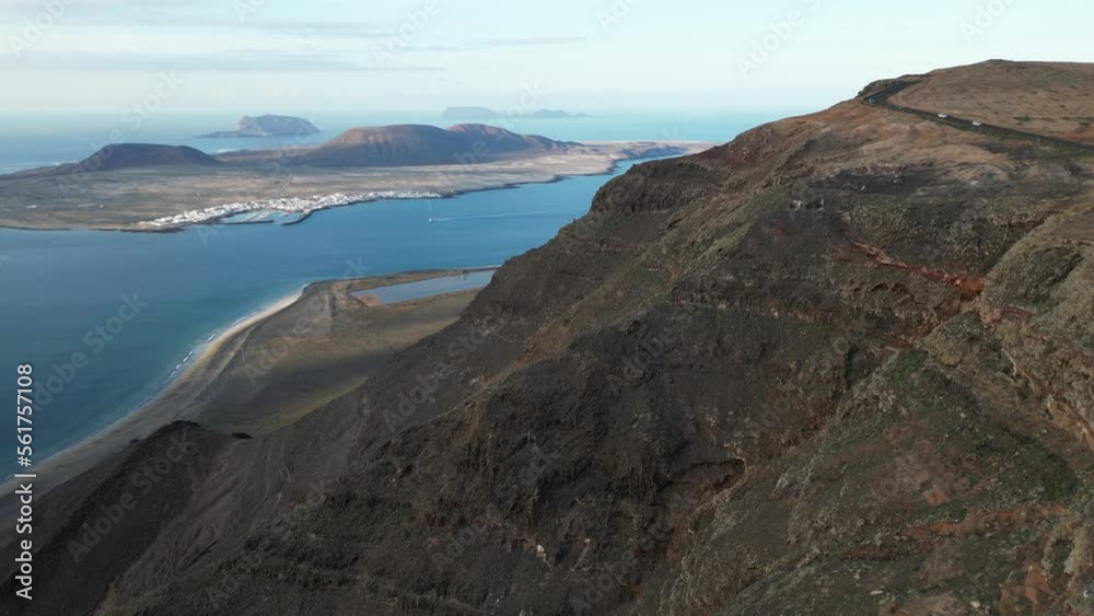 Spain , Lanzarote, Mirador del Rio ( Cesar Manrique ) - Drone aerial view in panoramic costal road overlooking the sea ocean and La Graciosa Island - Travel journey in volcanic landscape Spain , Lanzarote, Mirador del Rio ( Cesar Manrique ) - Drone aerial view in panoramic costal road overlooking the sea ocean and La Graciosa Island - Travel journey in volcanic landscape