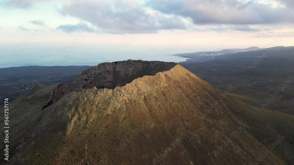 Drone aerial view of Volcán de La Corona is a 609 meters high extinct volcano on the Canary Island of Lanzarote, close to Yé and Haría in Canaries island , Spain - crater volcano view Drone aerial view of Volcán de La Corona is a 609 meters high extinct volcano on the Canary Island of Lanzarote, close to Yé and Haría in Canaries island , Spain - crater volcano view