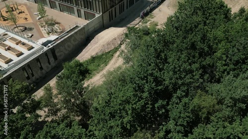 Drone flying over La Courrouze eco-district at Rennes city, Brittany in France. Aerial forward tilt-up reveal and sky for copy space photo