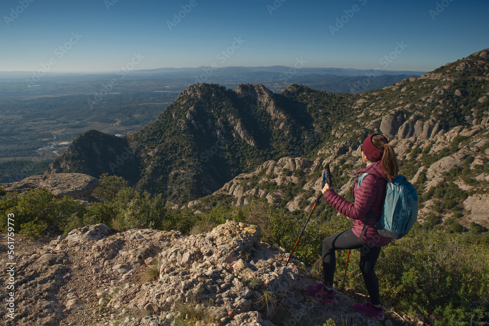 Woman walks and explores in the mountains very early in the morning.
