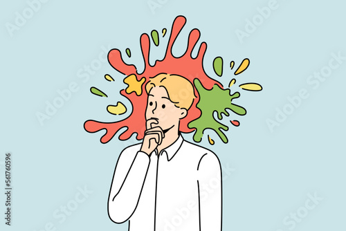 Pensive young male employee or worker with colorful splashes in head. Thoughtful businessman engaged in creative thinking. Vector illustration. 