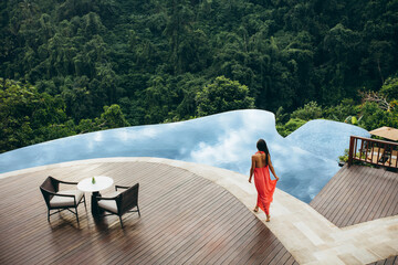 Woman at luxury resort poolside