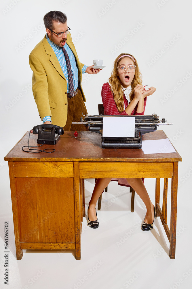 Emotional working day. Woman, personal assistant working on typewriter, businessman making comments Emotional working day. Woman, personal assistant working on typewriter, businessman making comments