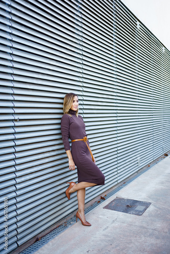 Businesswoman leaning on wall