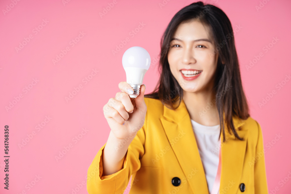 Image of young Asian businesswoman holding light bulb, brainstorm concept Image of young Asian businesswoman holding light bulb, brainstorm concept