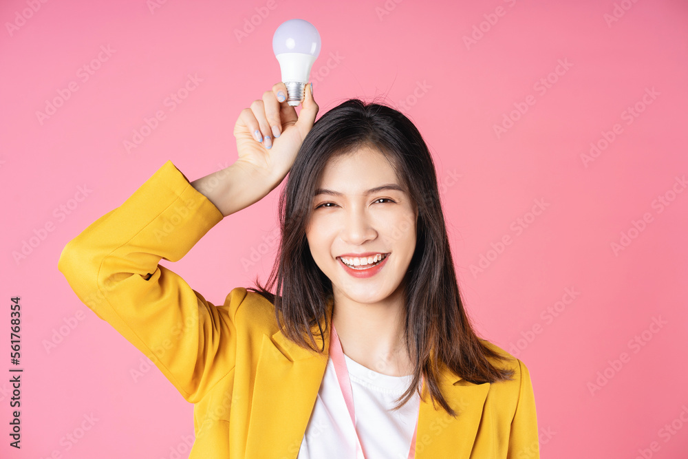 Image of young Asian businesswoman holding light bulb, brainstorm concept Image of young Asian businesswoman holding light bulb, brainstorm concept
