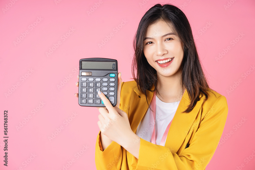 Image of young Asian businesswoman using calculator Image of young Asian businesswoman using calculator