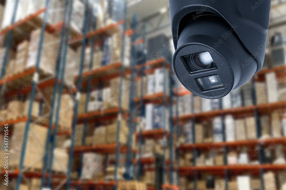 CCTV Camera Operating inside warehouse or factory. Copy space.