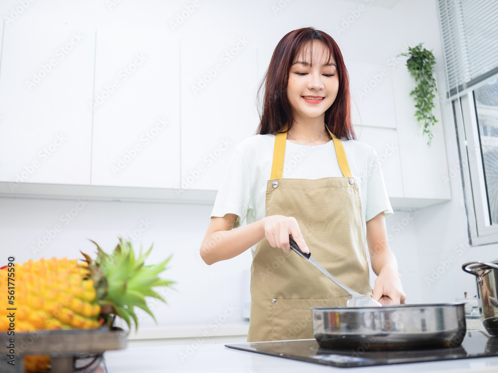 Image of young Asian woman in the kitchen