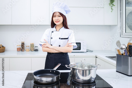 Image of young Asian woman chef in the kitchen