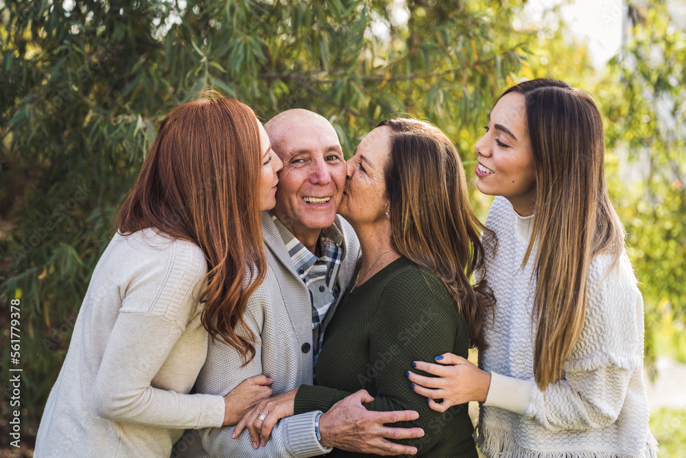 Portrait of multigenerational family hugging outside Portrait of multigenerational family hugging outside