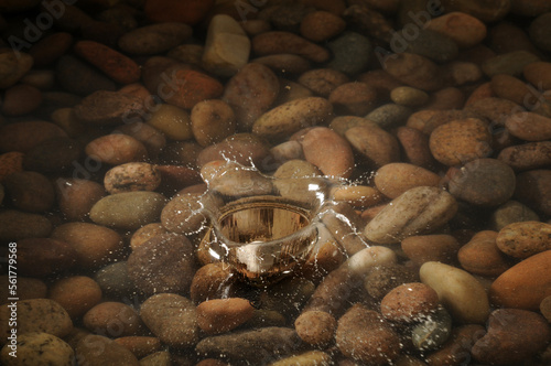 Canvas Print A pebble dropping into a shallow stony pool.