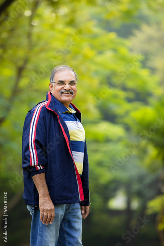 Indian old man giving expression at park.