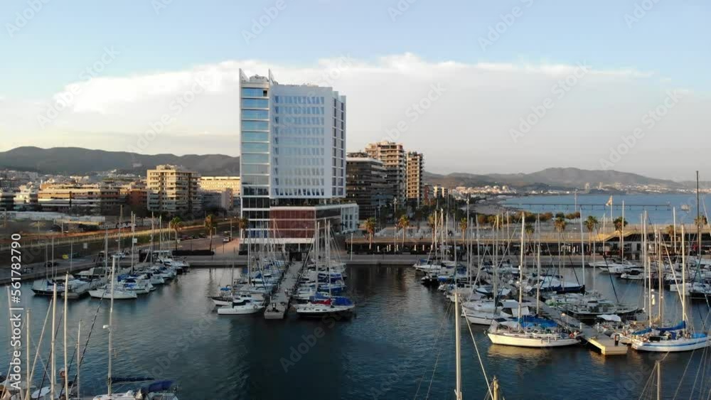 Sailboats in marina and buildings in a Port de Badalona at sunset, drone view Sailboats in marina and buildings in a Port de Badalona at sunset, drone view