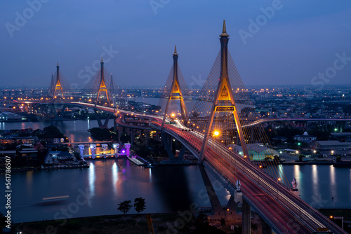 View of Bhumibol Bridge across the Chao Phraya River at night is a landmark of Bangkok and is a cargo road from the port to the city, Thailand.