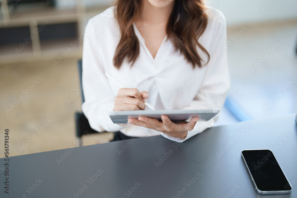 business owner or Asian female marketers are using tablet computer in office work business owner or Asian female marketers are using tablet computer in office work