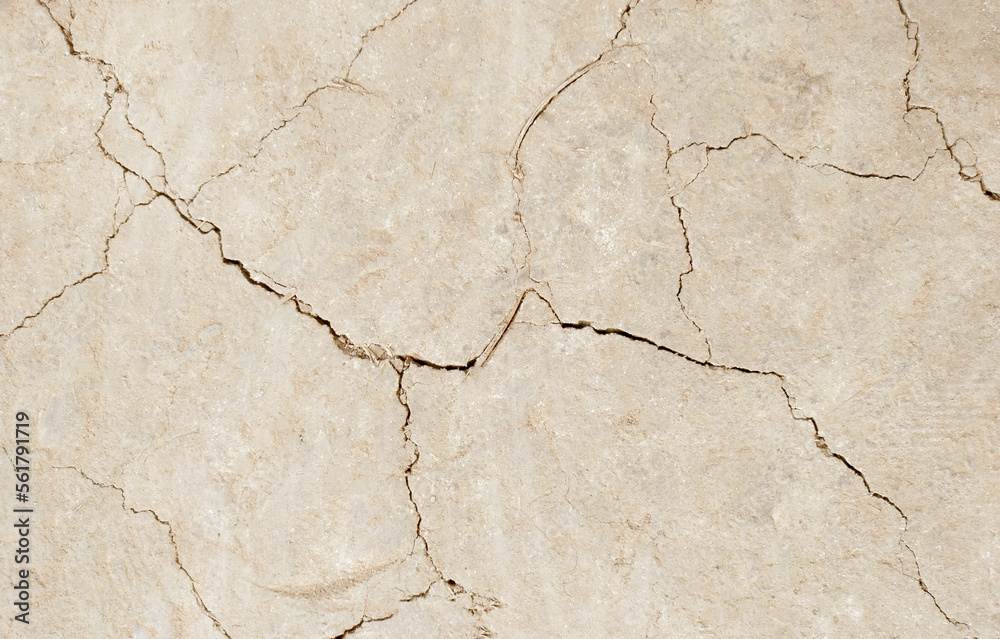 Fototapeta premium Cracked ground background in the top view for graphic design or wallpaper