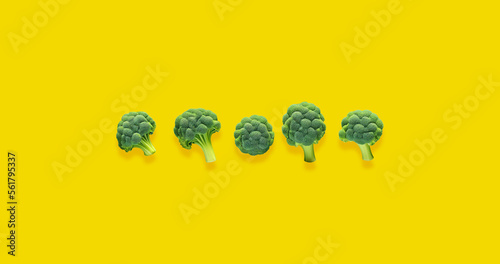 Tablou pe pânză Five broccoli on yellow background Vegan food Space for text Yellow background H