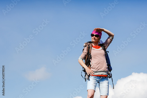 woman with backpack who hikers enjoys a break