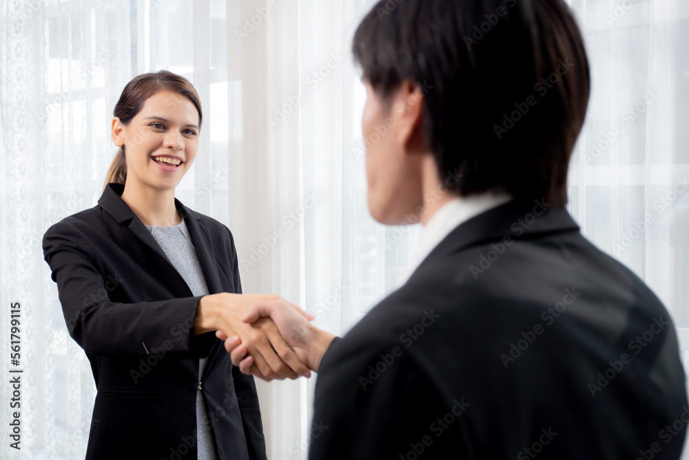 Happy business man and woman standing and shake hands while agreement of negotiation success and congratulations at office, businessman and partner handshake while greeting together, business concept. Happy business man and woman standing and shake hands while agreement of negotiation success and congratulations at office, businessman and partner handshake while greeting together, business concept.