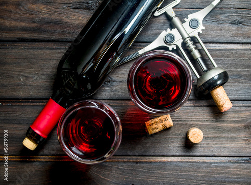 Wine background. Red wine with corkscrew.