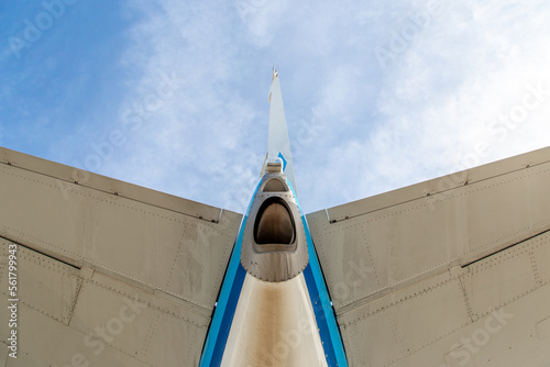 Looking up to the tail and stabiliser of a blue aircraft photo