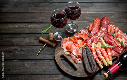 Antipasto background.Various assortment of meat snacks with red wine.