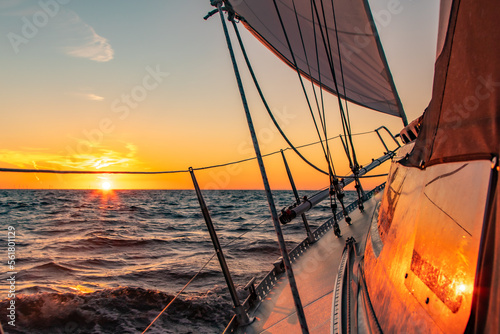 Dramatic orange sunset at sea seen from a sailboat