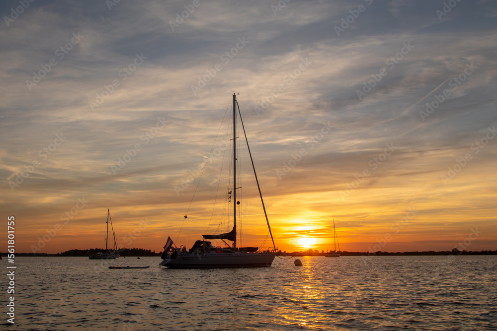 Sailing boat anchored with dramatic sunset