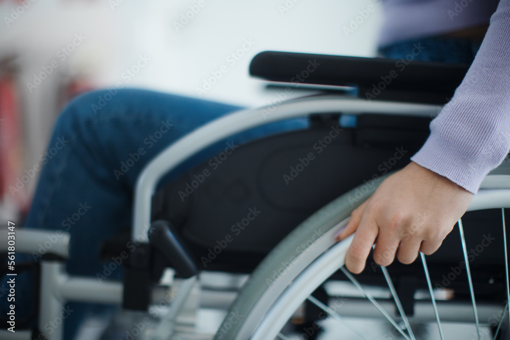 Close-up of young woman at wheelchair in hospital.