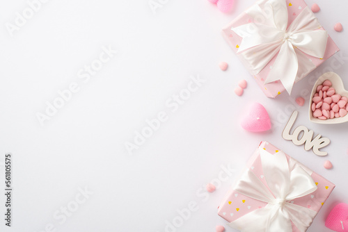 Valentine's Day concept. Top view photo of pastel pink present boxes with silk ribbon bows golden heart shaped confetti and sprinkles on isolated white background with copyspace