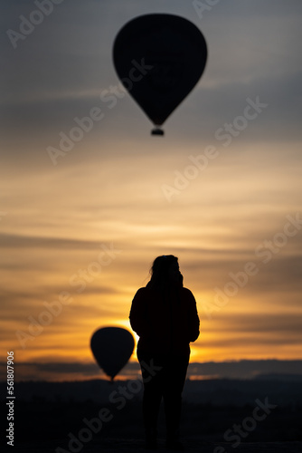 Hot Air Balloons and Woman Silhouette in Cappadocia at Sunrise