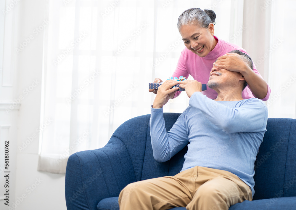 Senior Woman Surprises Her Husband With A Gift Box Happy Old Asian Senior Woman Surprises Her Husband With A Gift Box Happy Old Asian