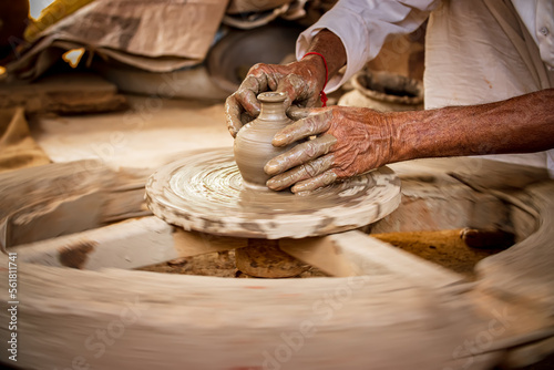 Potter at work makes ceramic dishes. India, Rajasthan. photo