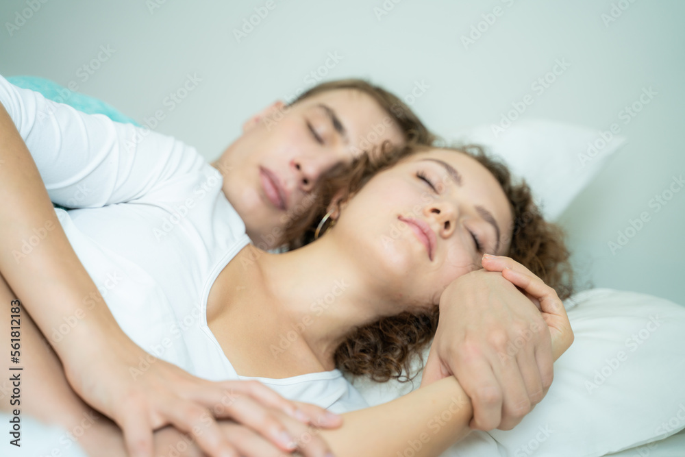 Lovely couple sleeping on white bed morning scene Lovely couple sleeping on white bed morning scene