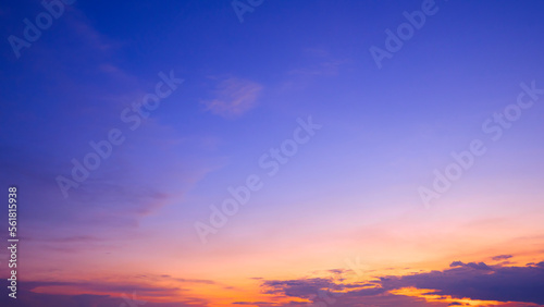 Colorful dusk sky with yellow sunlight and Sunset cloud on dark blue Twilight sky background © Prapat