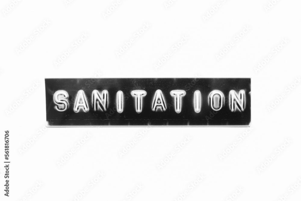 Embossed letter with word sanitation in black banner on white paper background Embossed letter with word sanitation in black banner on white paper background