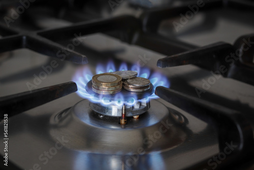 Burning natural gas and british coins on gas hob. The concept of the struggle for global gas markets. North stream