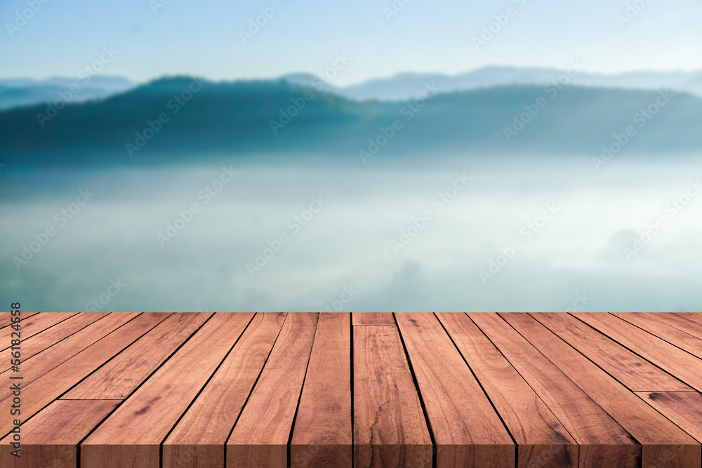 Blank space on a wooden table for product display with blurred natural landscape background.
