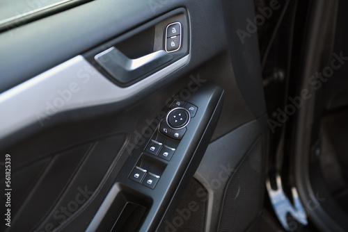 Close-up of side door buttons: window adjustment buttons, door lock. modern car interior: details, buttons, knobs