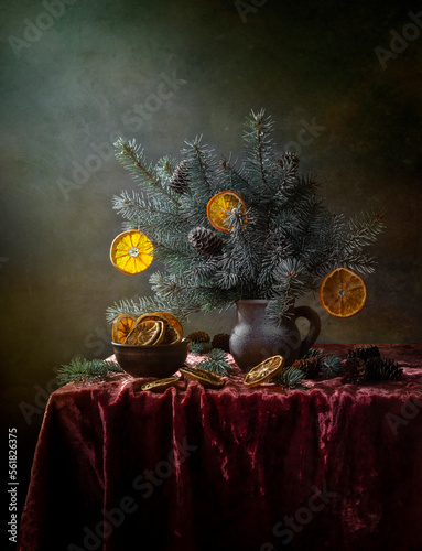 Winter still life with spruce branches and dried oranges photo