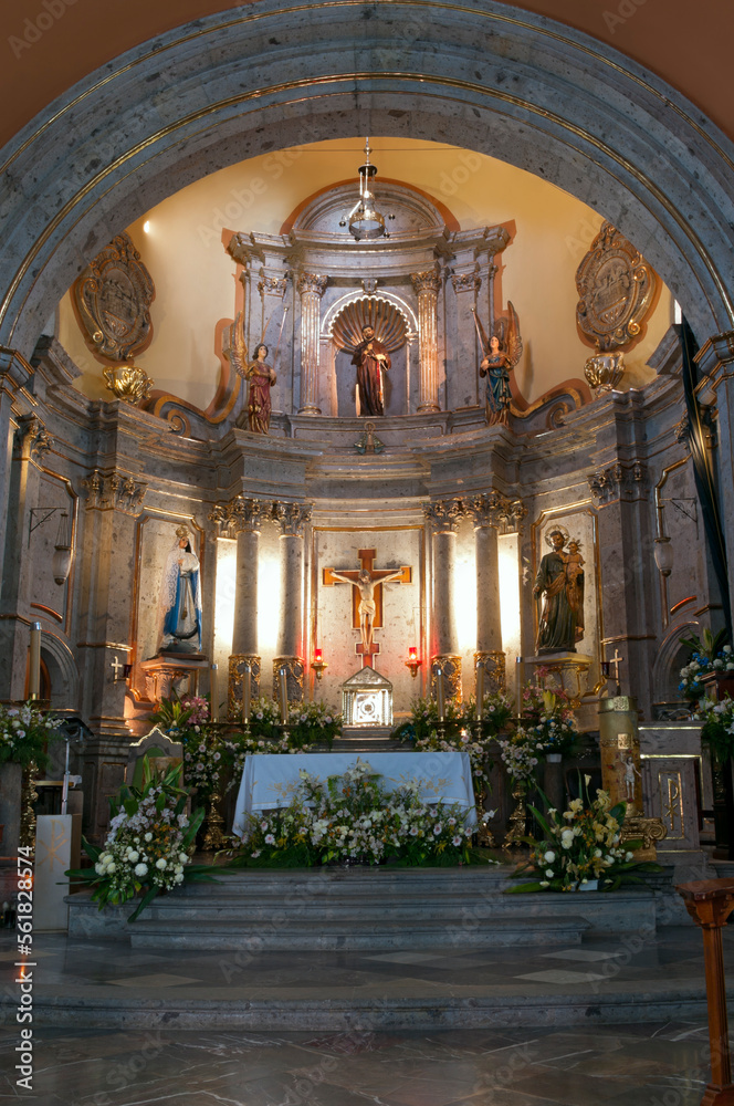 church interior in chapala mexico with arch framing altar and columns illuminated 