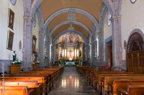 church interior in chapala mexico with columns and arches forming nave and illuminated altar photo