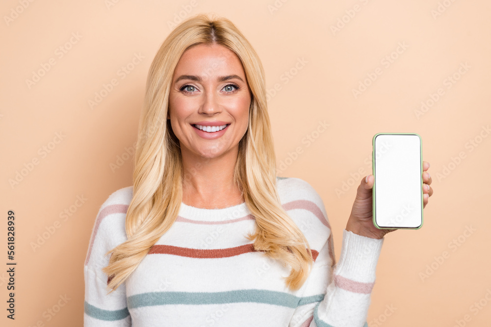 Portrait of lovely pretty positive girl wavy hair wear striped pullover hold phone demonstrate screen isolated on pastel color background Portrait of lovely pretty positive girl wavy hair wear striped pullover hold phone demonstrate screen isolated on pastel color background