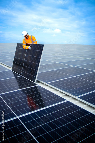 Wallpaper Mural Installing solar power plant as sustainable energy source. Worker placing solar panel on the roof. Torontodigital.ca