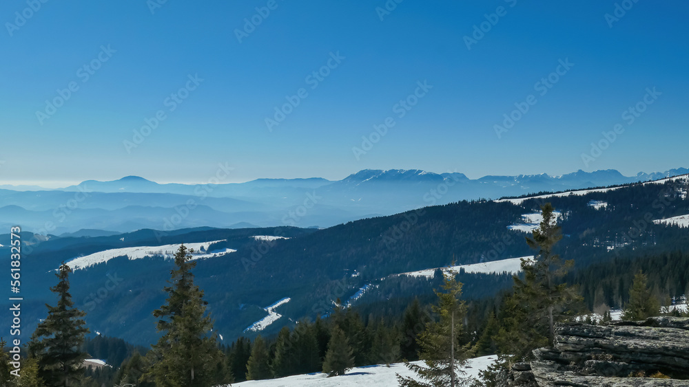 Scenic view of alpine meadows, high altitude forest and hills seen from hiking trail to Ladinger Spitz, Saualpe, Lavanttal Alps, Carinthia, Austria, Europe. Karawanks mountain range in the background