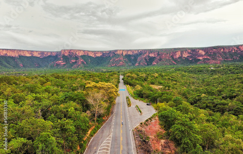 Fascinating road leading to the rocky formation of chapada dos guimarães with a dense forest photo