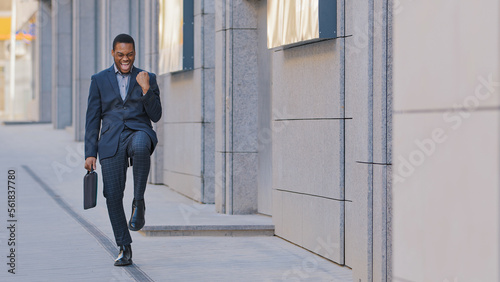 Happy success African American man candidate hired has job offer ethnic worker manager intern businessman winner outdoors feel excited yes gesture celebrating professional triumph victory opportunity photo