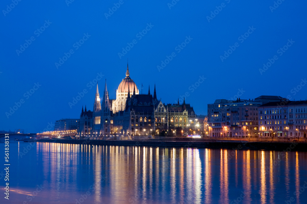 the Parliament Building at night, Budapest, Hungary, with lights reflected in the Danube.