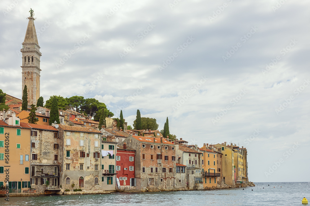 The old town of Rovinj with the Adriatic Sea in the background and with the Church of St. Euphemia rising high above the houses